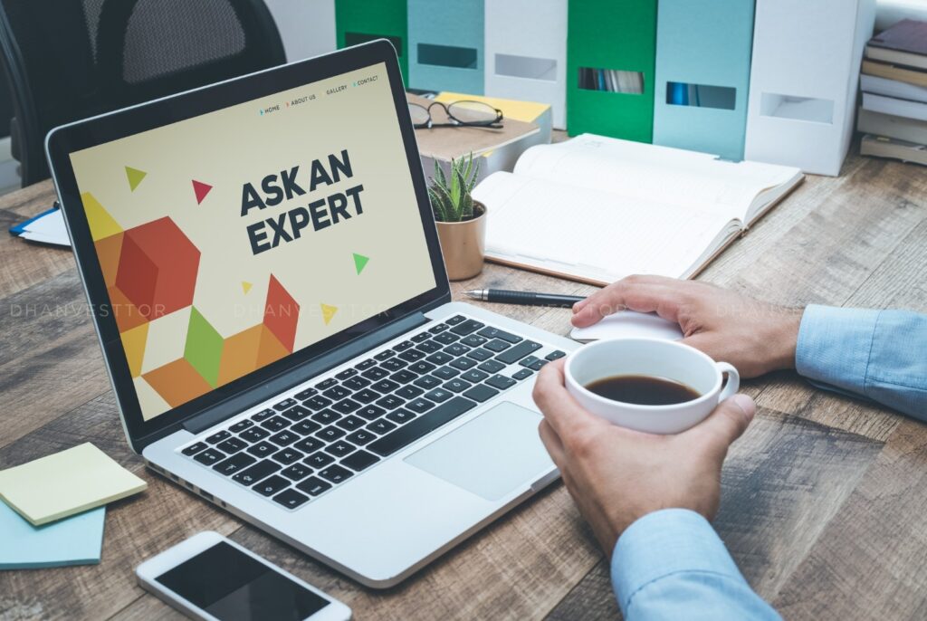 Finance Expert Analysing Portfolio Finance Expert Sitting on Desk with Coffee Cup